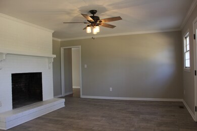 Den is next to Kitchen and has Wood Burning Fireplace; Also has Exterior Door leading to Large Patio