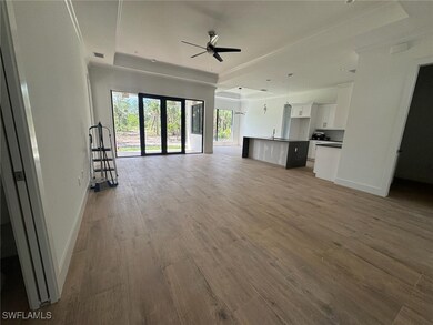 Living room with ceiling fan, wood finished floors
