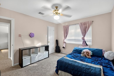 Bedroom featuring carpet floors and a ceiling fan