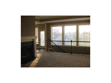 Large great room with fireplace and lots of light