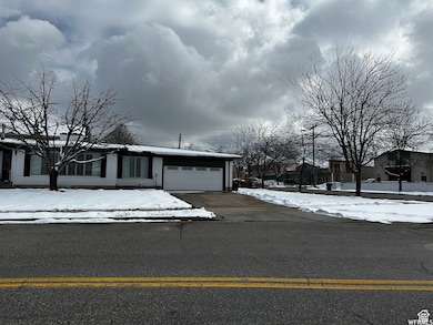 View of front of home with driveway and a garage