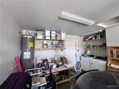 Garage featuring electric water heater and washer