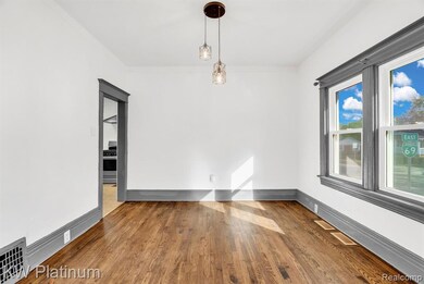 Unfurnished dining area with wood finished floors and baseboards