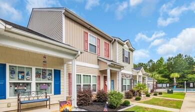 Multi unit property featuring board and batten siding and a community pool