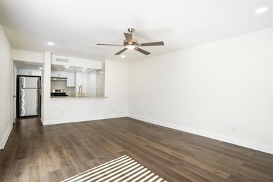 Unfurnished living room with visible vents, dark w