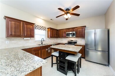 Kitchen with granite countertops and tiled backspl