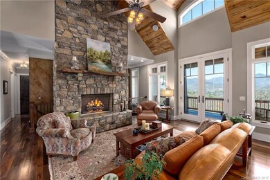 A Massive Stone Fireplace and Soaring Ceilings are