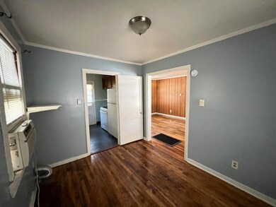Unfurnished bedroom with ornamental molding, white