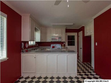 Black, white & red all over! Kitchen with classic color combination has new range/oven & faucet. Easy-care vinyl flooring.