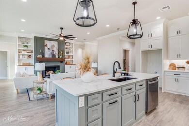 Kitchen featuring sink, dishwasher, light stone co