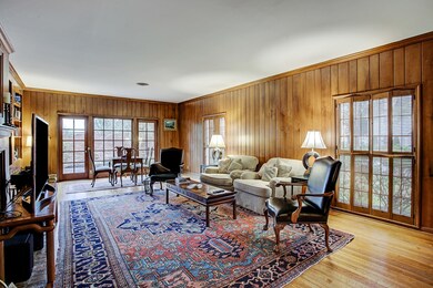 Paneled family room with views to the front and west side patio area.