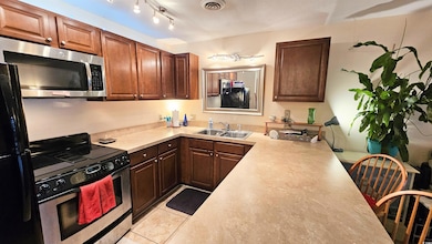 Kitchen featuring light tile patterned floors, vis