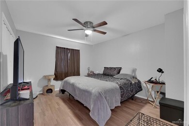 Bedroom with ceiling fan and light hardwood / wood-style floors