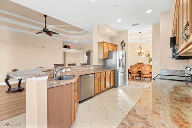 Kitchen with sink, a kitchen bar, a tray ceiling,