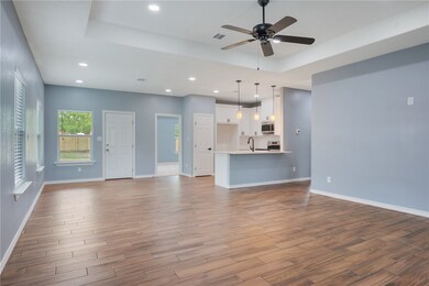 Unfurnished living room with a tray ceiling, a cei