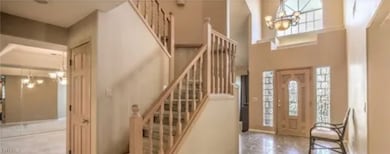 Foyer entrance featuring a chandelier and stairs