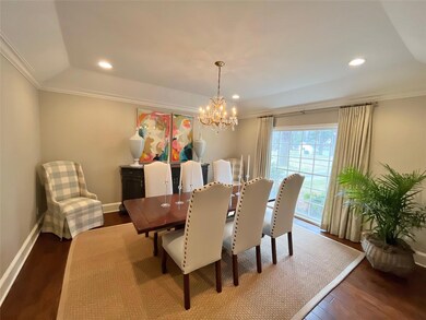 Dining area featuring dark wood-style flooring, a 