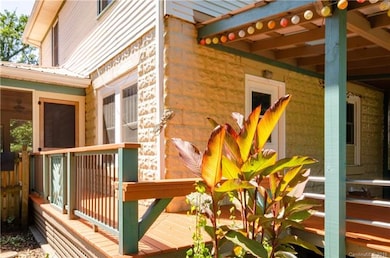 Closed in Side Porch (left) with covered Deck