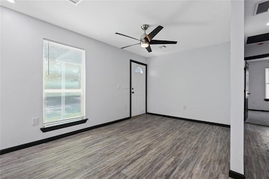 Unfurnished room with wood finished floors, a ceil