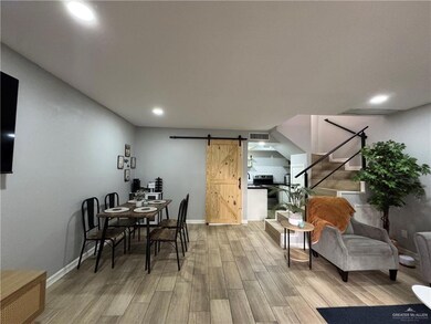 Dining space featuring a barn door and light hardwood / wood-style floors