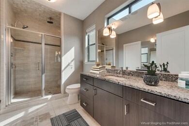 Full bathroom featuring vanity, a shower stall, and light tile patterned floors