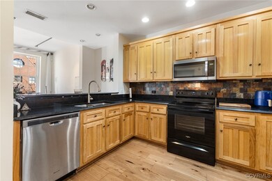 Kitchen featuring a peninsula, a sink, decorative