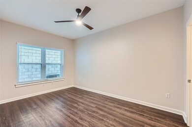 Spare room featuring dark wood finished floors an