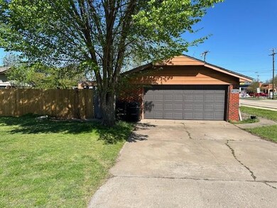 Ranch-style home with a front yard and a garage