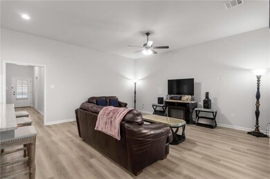 The living room has large windows and an open-conc