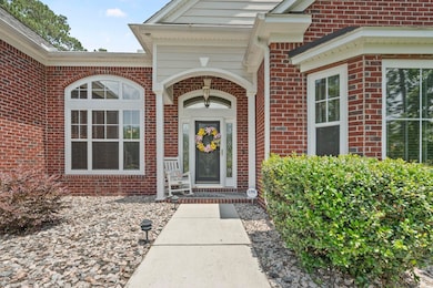 View of exterior entry featuring brick siding