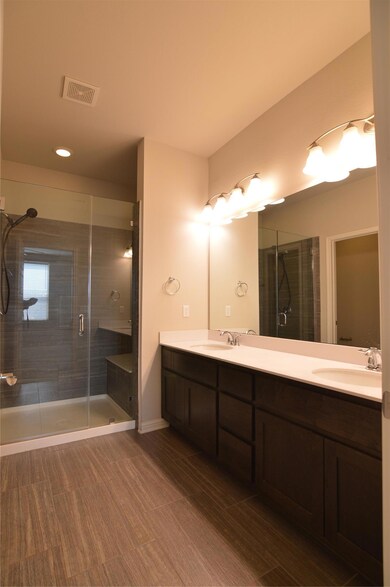 Bathroom with double vanity and a stall shower