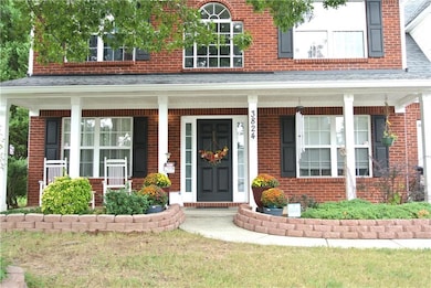 Property entrance featuring a yard and a porch