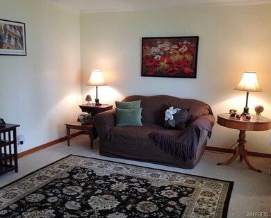 Living room-crown moldings and berber carpeting
