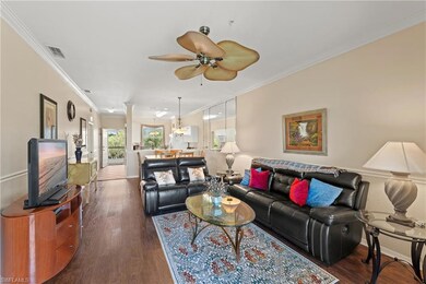 Living room featuring ceiling fan, crown molding, 