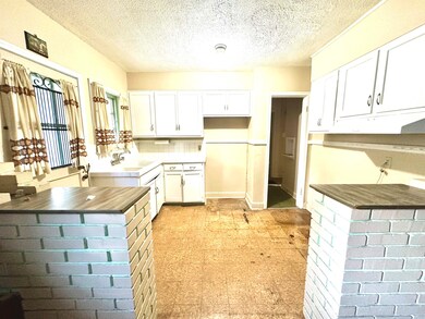 Kitchen with backsplash, butcher block countertops