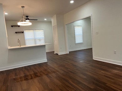 Unfurnished living room with dark wood-style floors and recessed lighting
