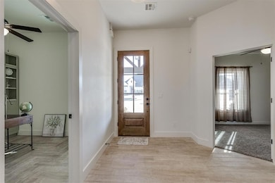 Entrance foyer featuring light wood-look tile floo
