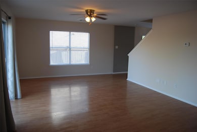 Empty room featuring baseboards, ceiling fan, and