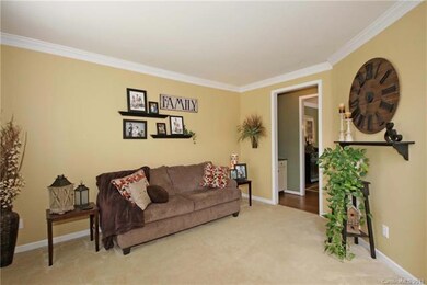 Formal living room with crown molding and neutral 