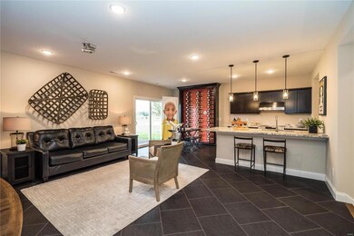 Lower level kitchen with electric range, mircowave, dishwasher, breakfast bar and entertaining space