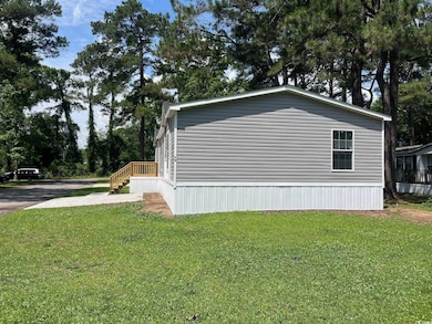 View of property exterior with a lawn