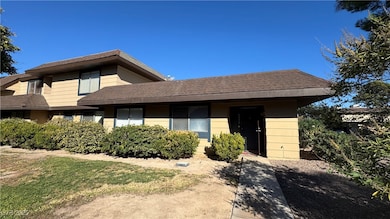 View of front of home featuring roof with shingles and a front yard