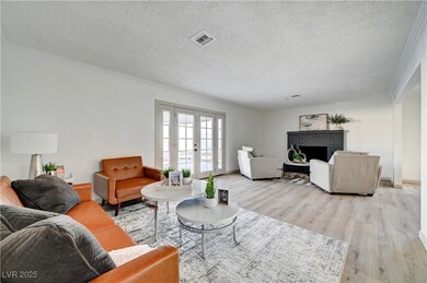 Living room featuring french doors, a fireplace, a