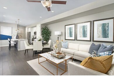 Living area featuring dark wood-style floors, recessed lighting, and ceiling fan