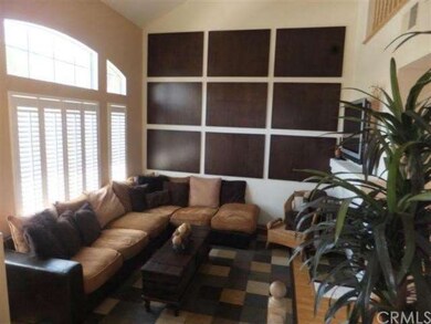 Living room features plantation shutters, high cat