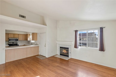Unfurnished living room with a sink, light wood-st