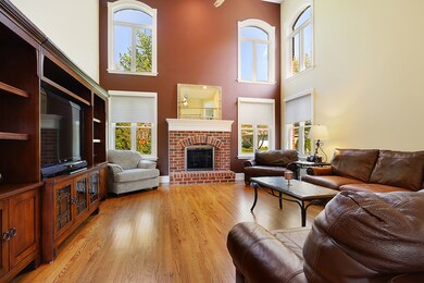Dramatic family room with hardwood floors, gas fir