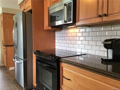 Kitchen complete with subway tiles, glass top stov