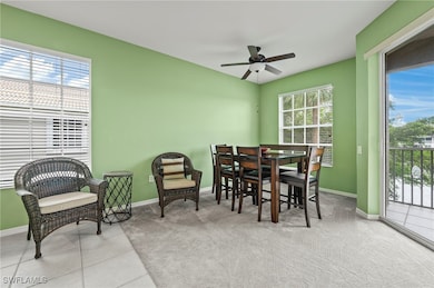Dining space with light carpet and ceiling fan