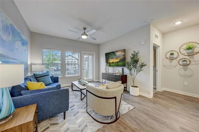 Living area with visible vents, light wood-style f